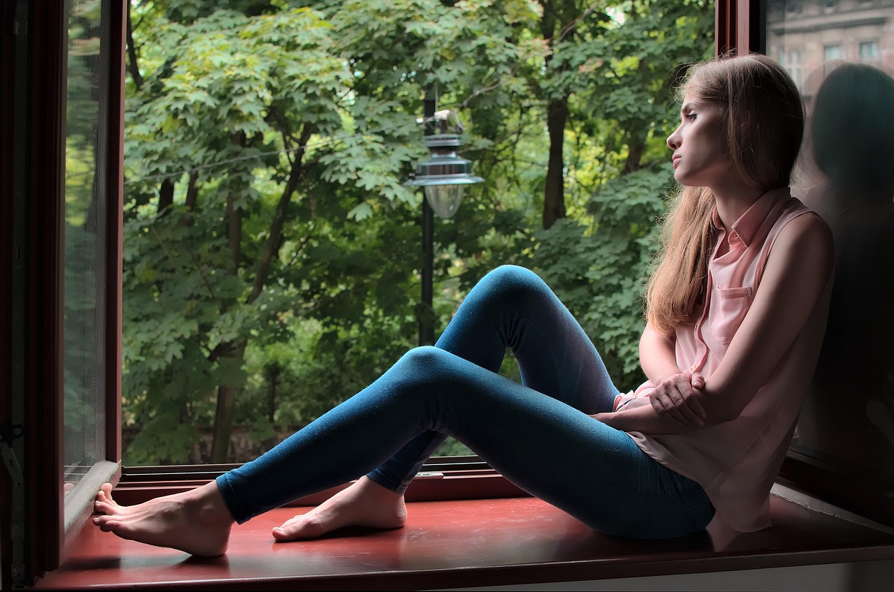A quiet moment beside a window overlooking trees